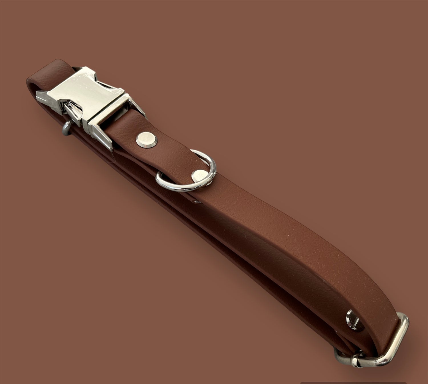 Quick-release BioThane® dog collar in Saddle Brown, featuring a sturdy plastic buckle for easy on-and-off, with a sleek, waterproof, and durable design.
