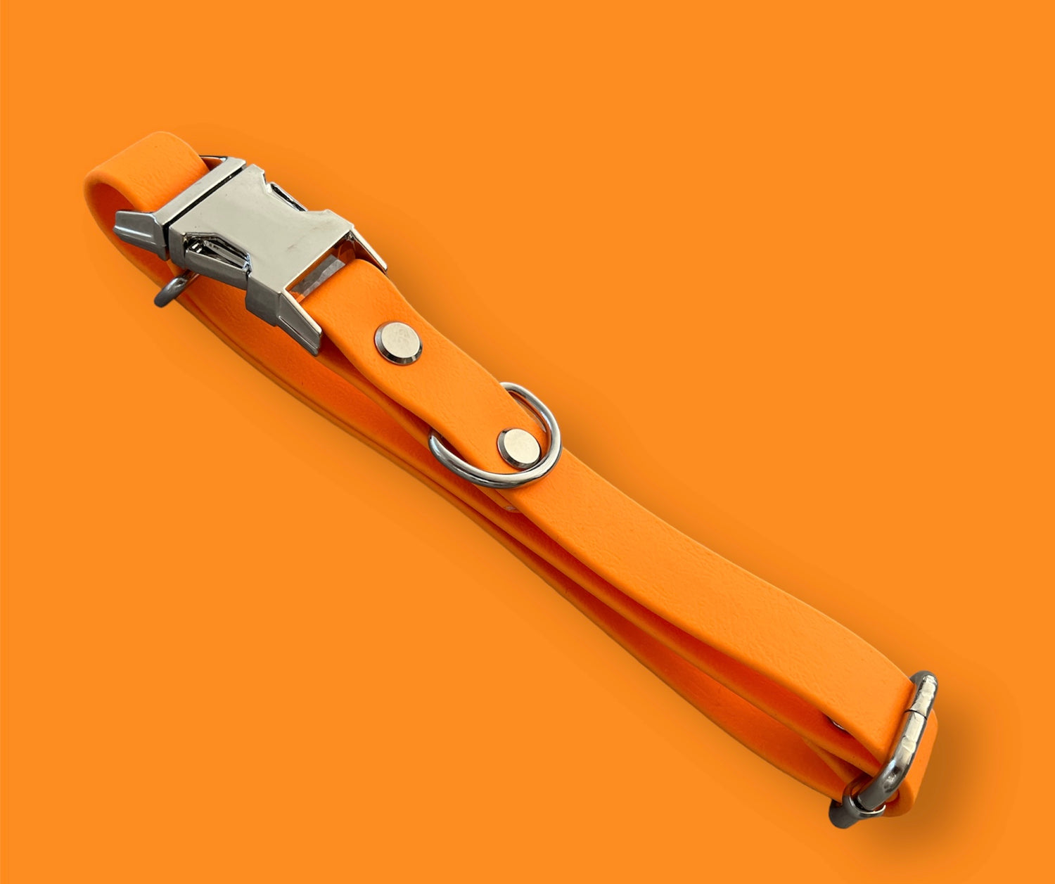 Quick-release BioThane® dog collar in Tangy Orange, featuring a sturdy plastic buckle for easy on-and-off, with a sleek, waterproof, and durable design.